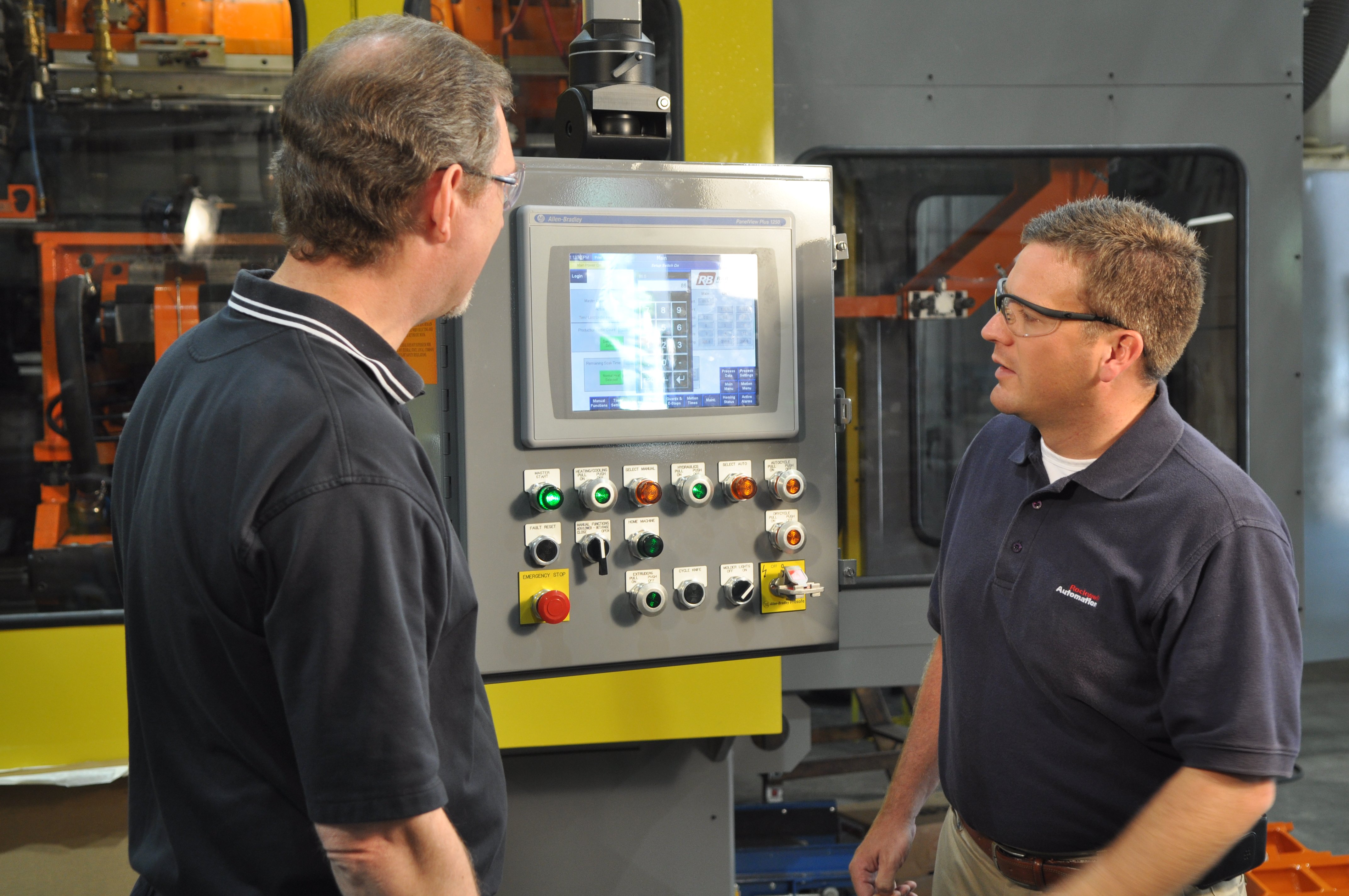 two men observing the display of the optix panel