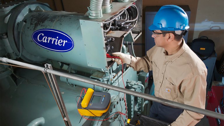 Maintenance staff working on electrical panel.