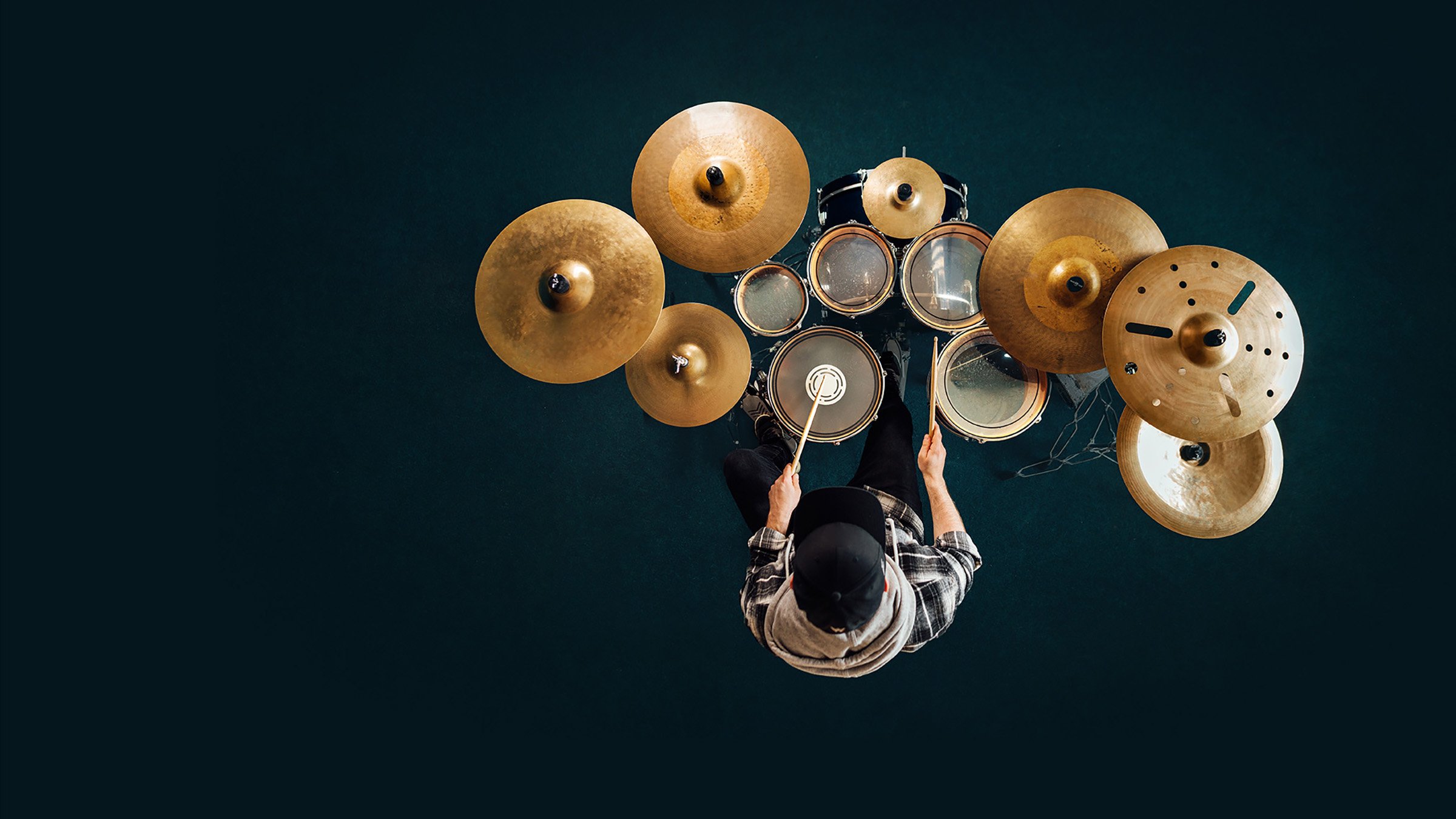 man playing gold drum set