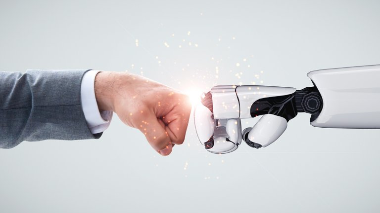  AI robot arm fist bumping male arm in gray business suit representing the collaboration of man and computer