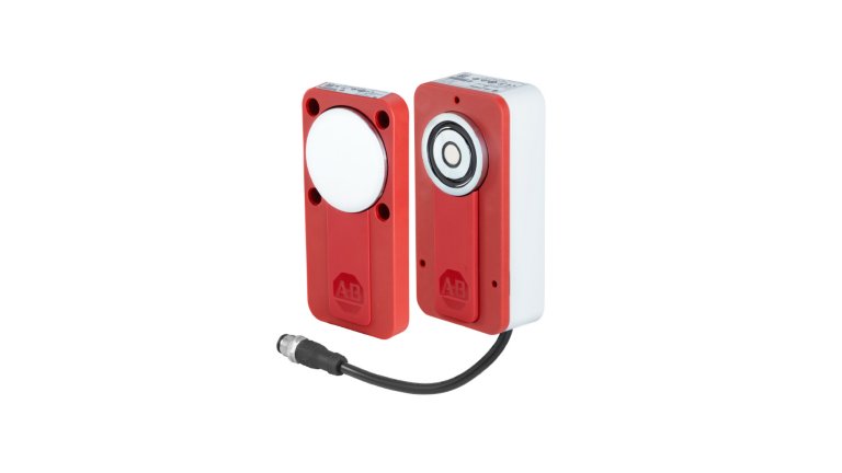 Two-piece rectangular red interlock switch, one with a silver circular target and another with a silver sensing face and a black cord coming out of the bottom