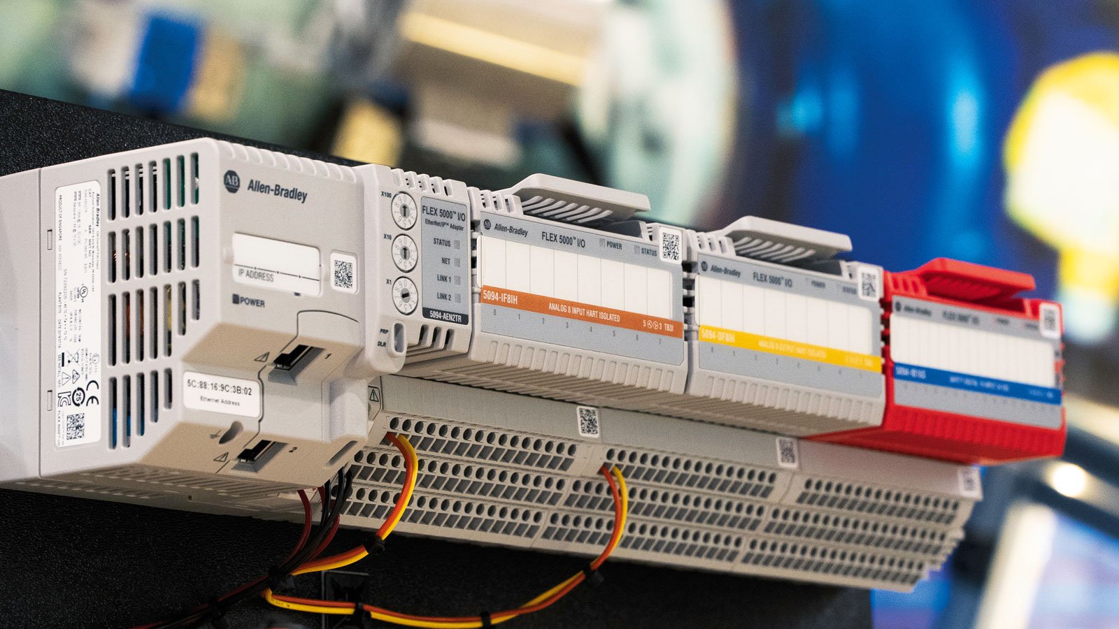 One Allen-Bradley® FLEX 5000™ EtherNet/IP adapter, two standard and one safety Allen-Bradley® FLEX 5000™ I/O modules are mounted on a rack, facing to a right angle. This image shows the distributed I/O solution for an application in a real-life environment 