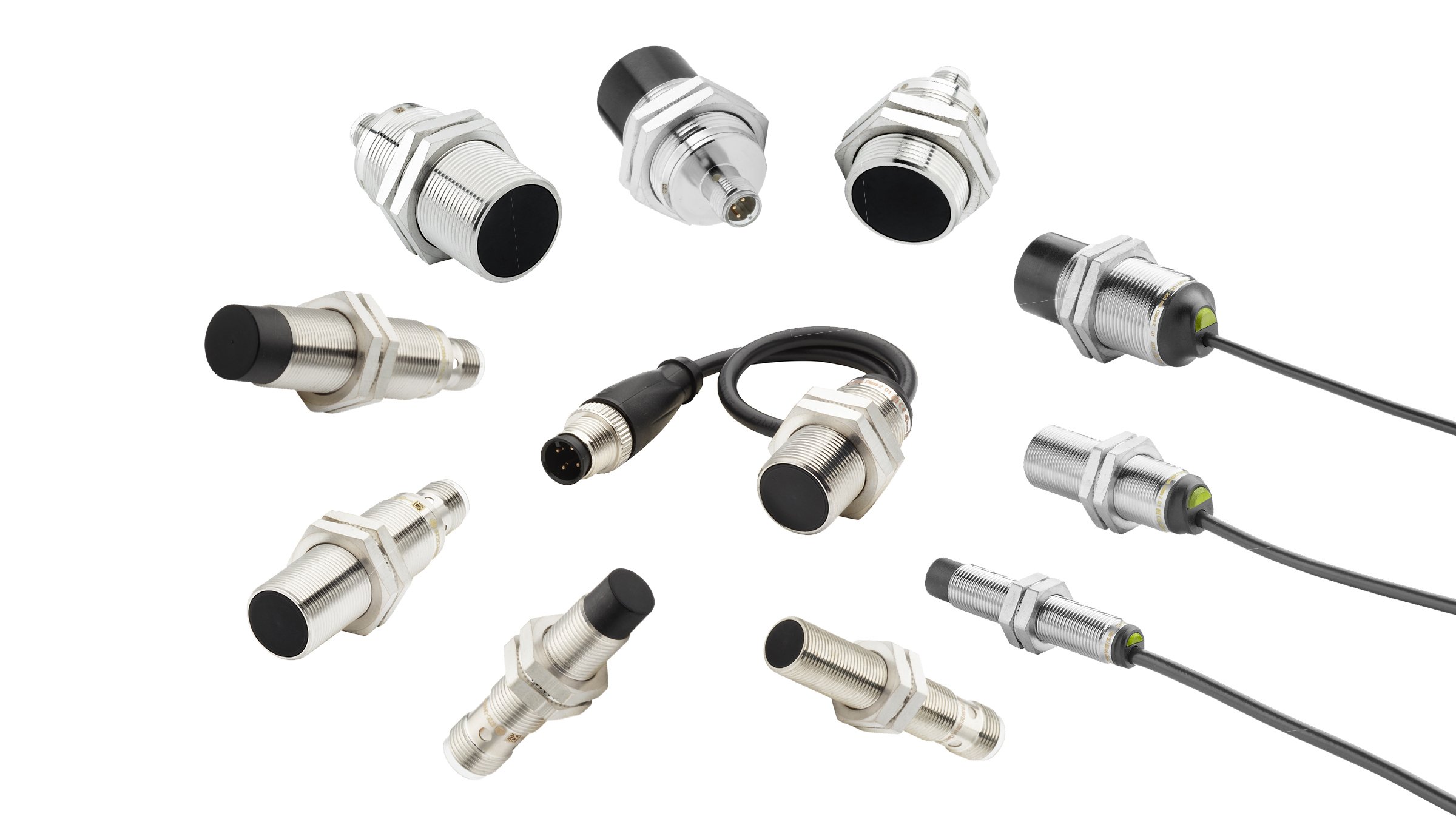 Family shot of 11 tubular inductive proximity sensors with threaded, nickel-plated brass barrels. Arranged in various angles showing either the black sensing face or the connection ends.