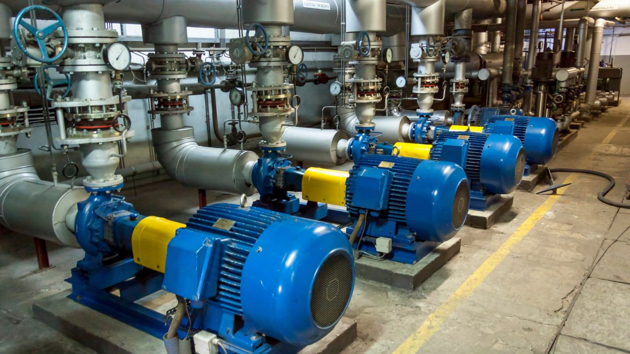 A collection of industrial pumps positioned within a factory