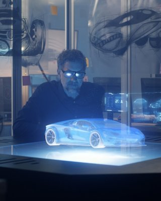 Concentrated operator in eyeglasses drawing design of sports car in 3D using modern computer