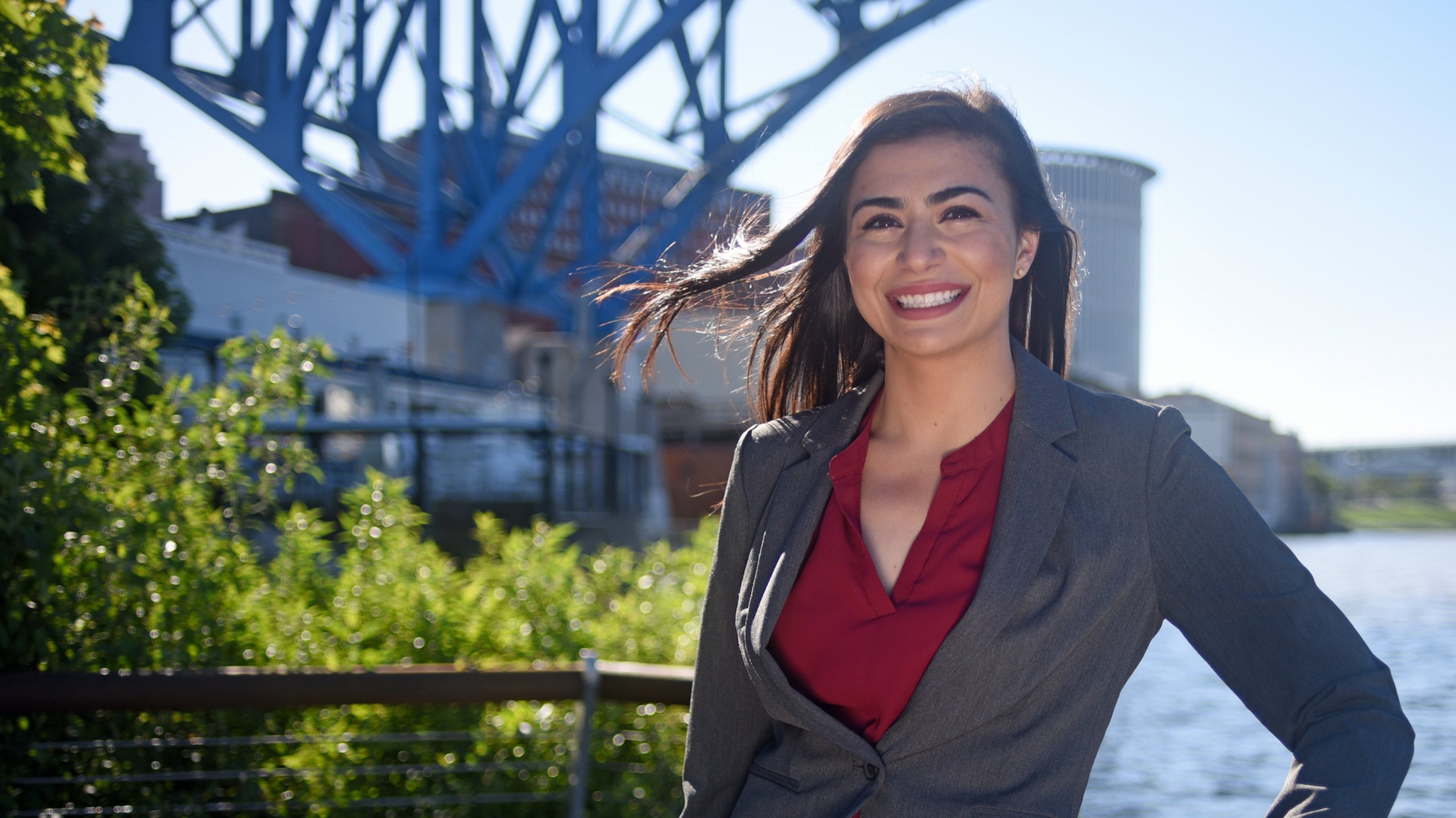 Allie Schwertner, sustainability technology and strategy leader at Rockwell Automation, poses on the bank of the Cuyahoga River in Cleveland.