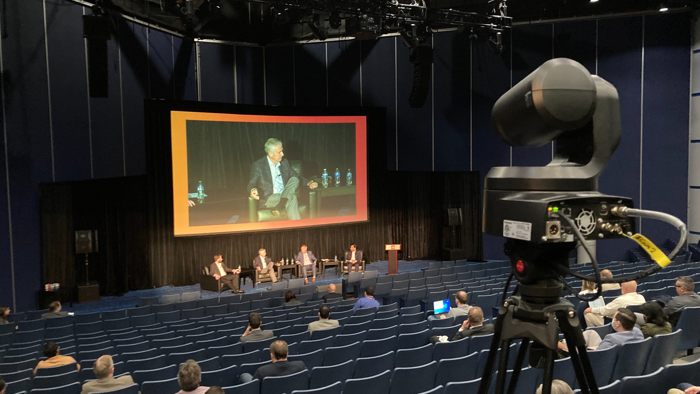 Los miembros del panel que representan los OEM líderes aparecen en el escenario delante de una pantalla grande.