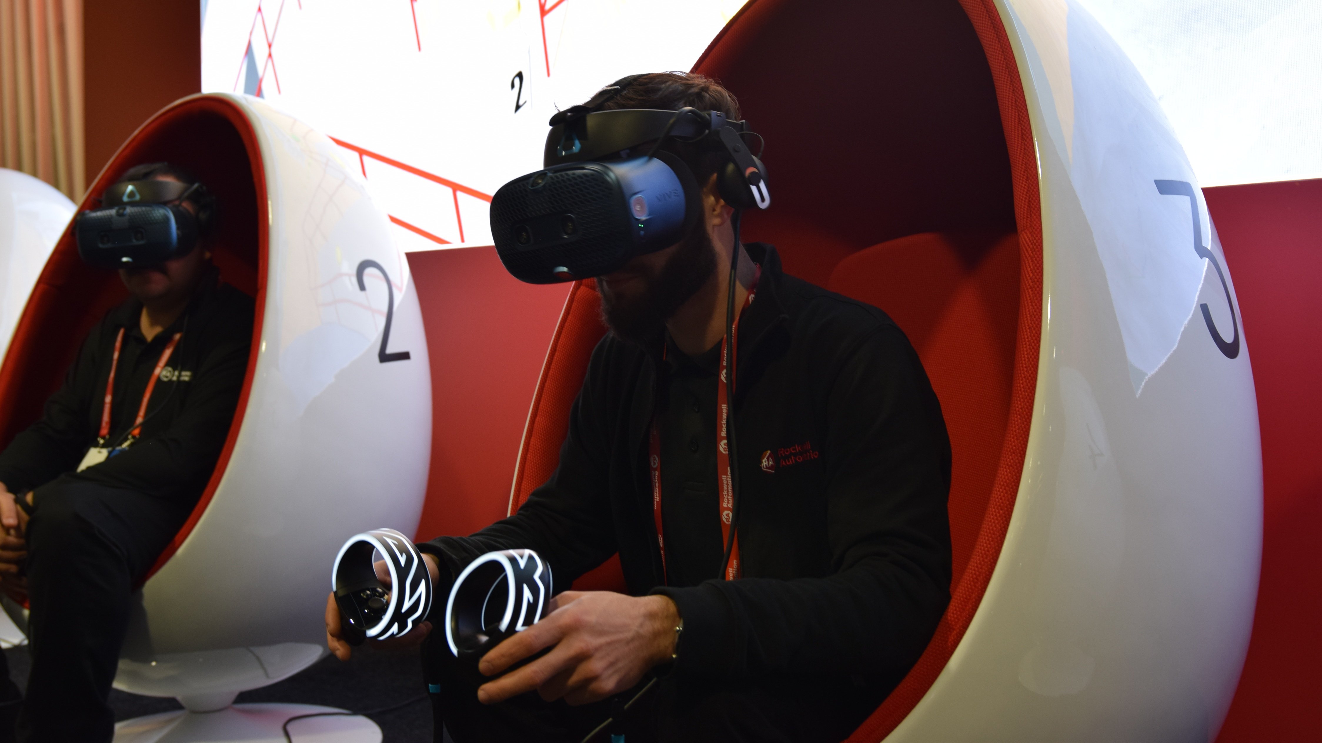 Rockwell Automation employee wearing VR glasses and holding controllers