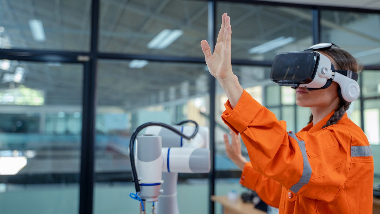 Woman engineer using virtual reality glasses in smart manufacture