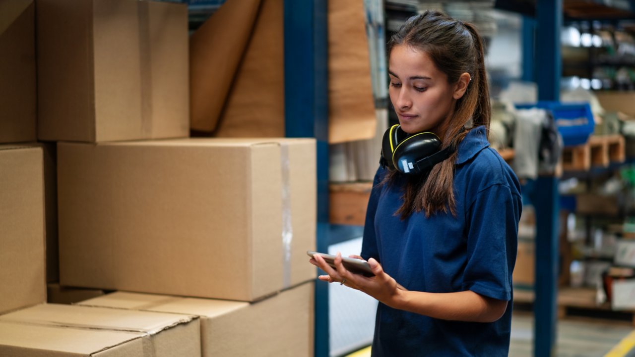 Employee tracking packages on her tablet