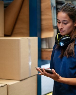 Employee tracking packages on her tablet