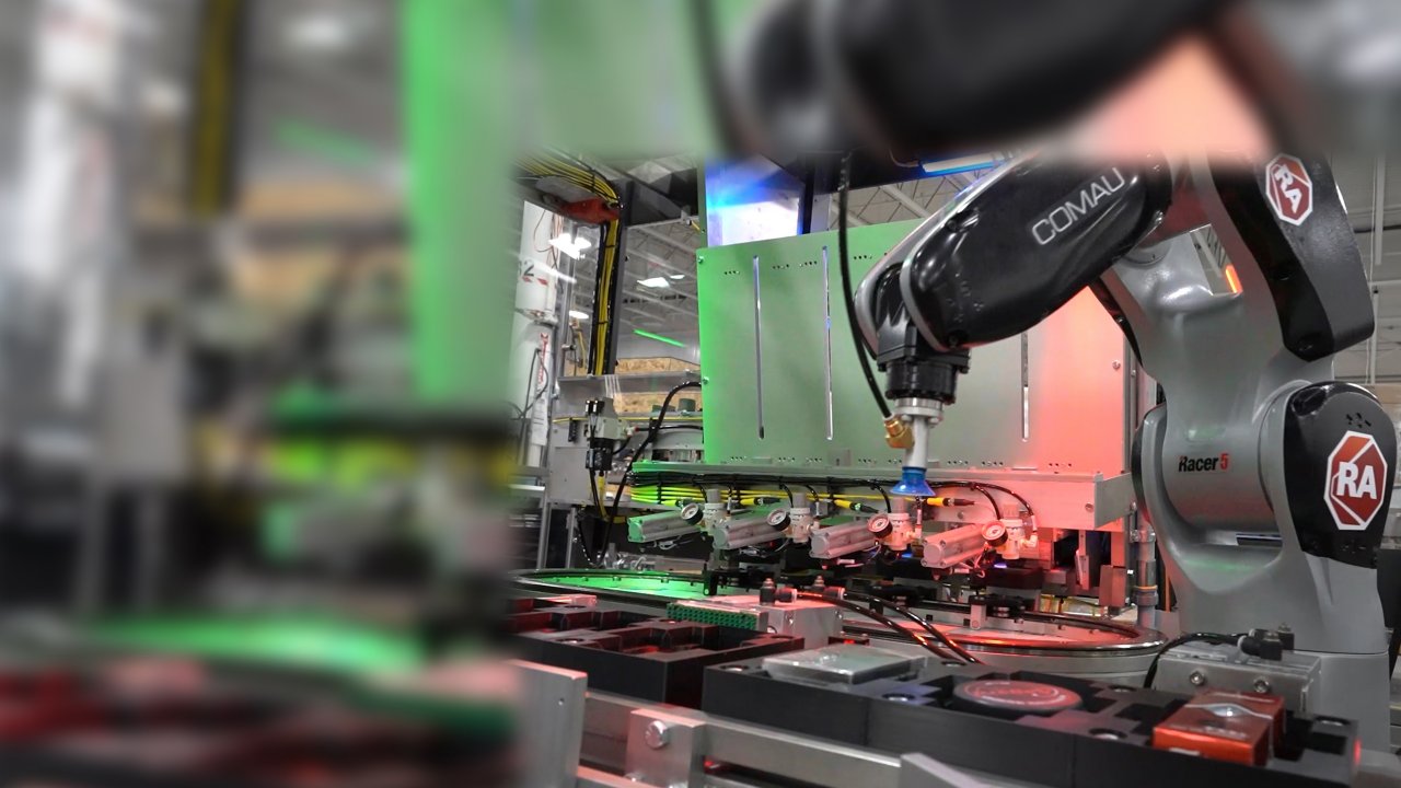 Prototype packaging machine uses an articulating arm robot to select products from an iTRAK independent cart technology conveyance system