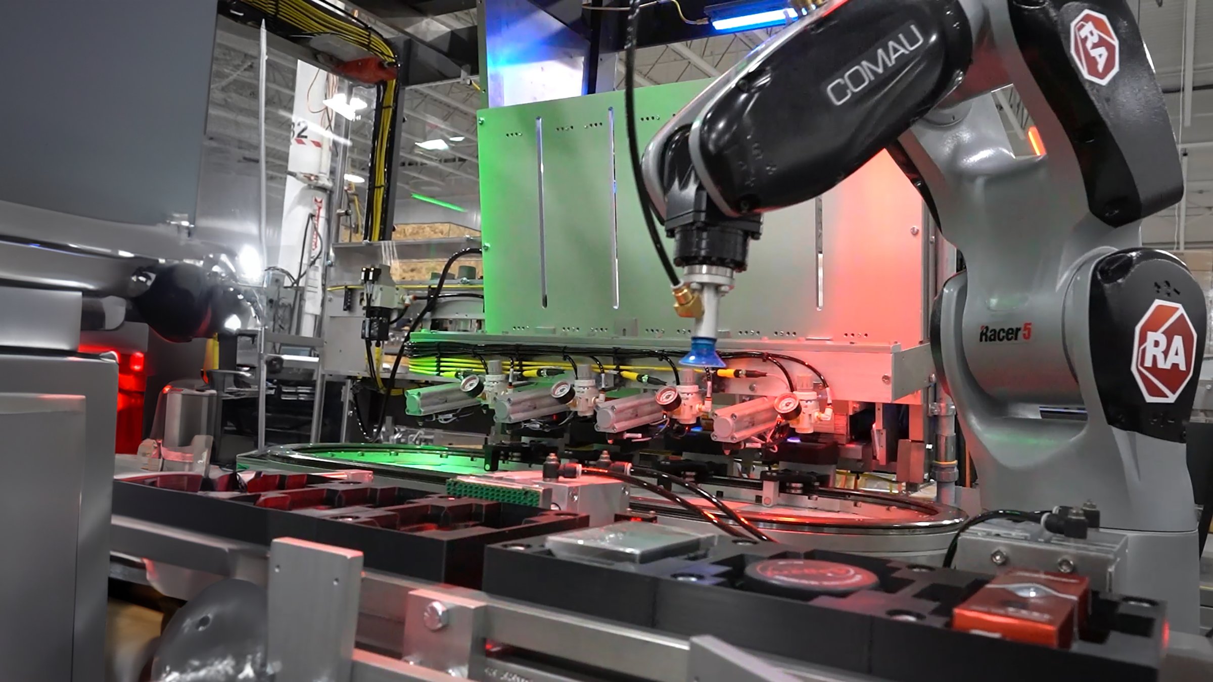 Prototype packaging machine uses a Comau articulating arm robot 