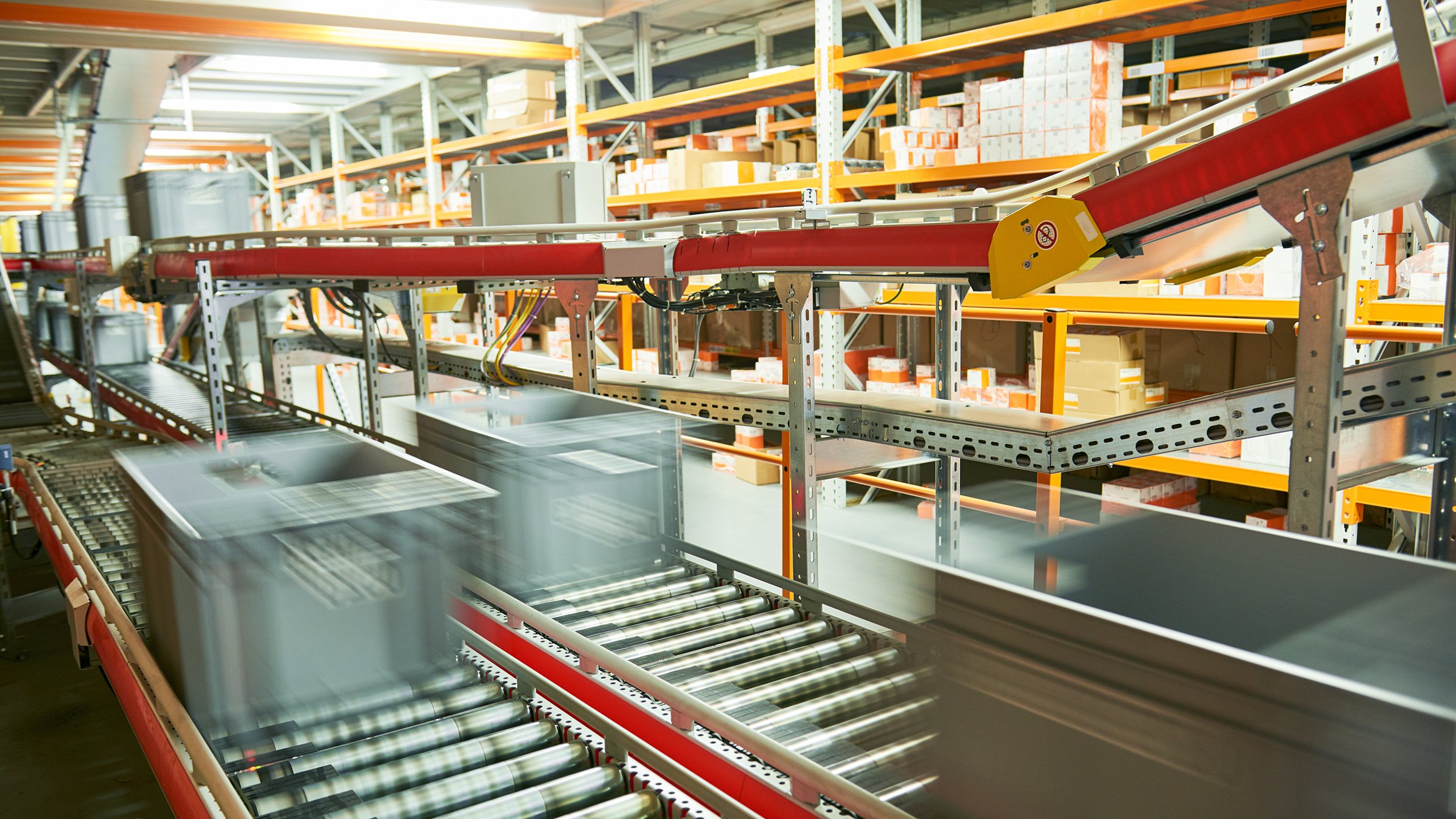 Automated warehouse. Boxes with spare parts moving on conveyer