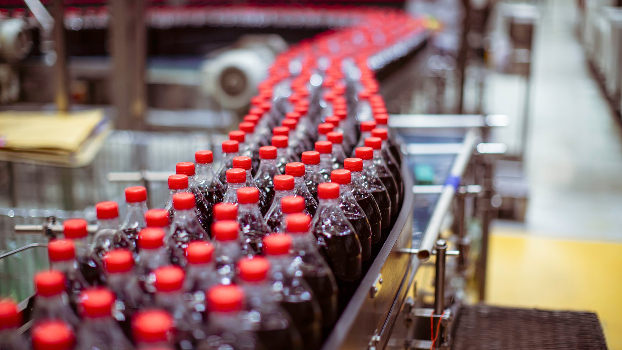 Beverage factory interior. Conveyor flowing with bottles for carbonated water.