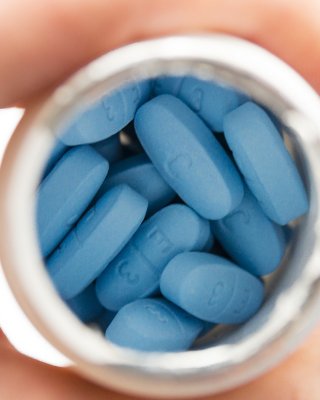 Blue pills made by Pfizer in plastic bottle