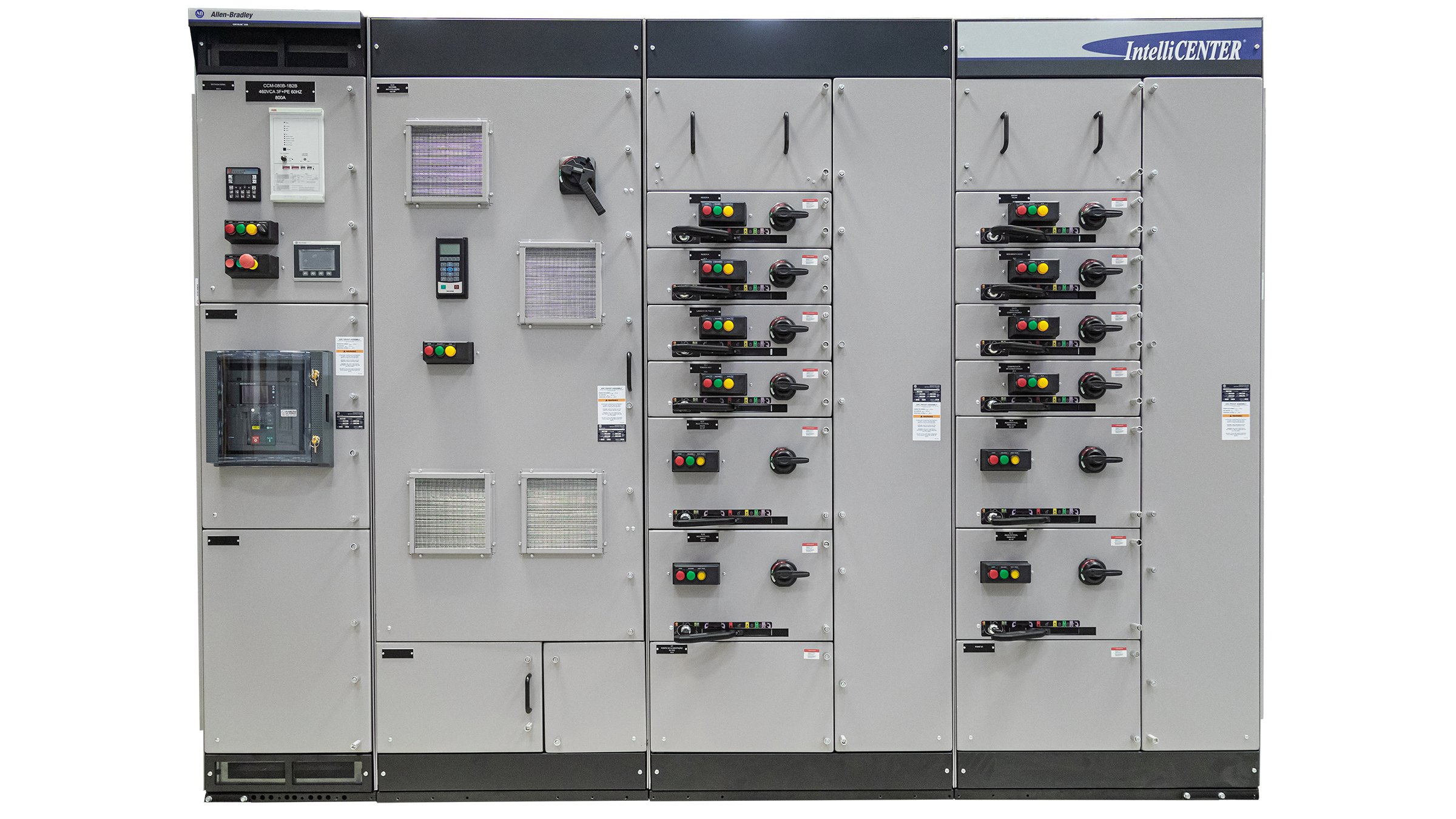 A large gray metal cabinet is facing directly toward viewers. Divided by four vertical sections, this industrial container features 18 different-sizes doors with handles, LED lights, switches, keypads, vents and or/multi-colored buttons.