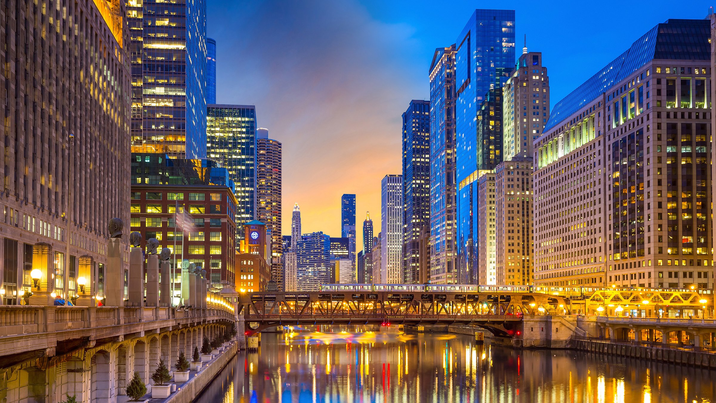 Chicago downtown and Chicago River at night in USA. Buildings and lights reflected in the water.