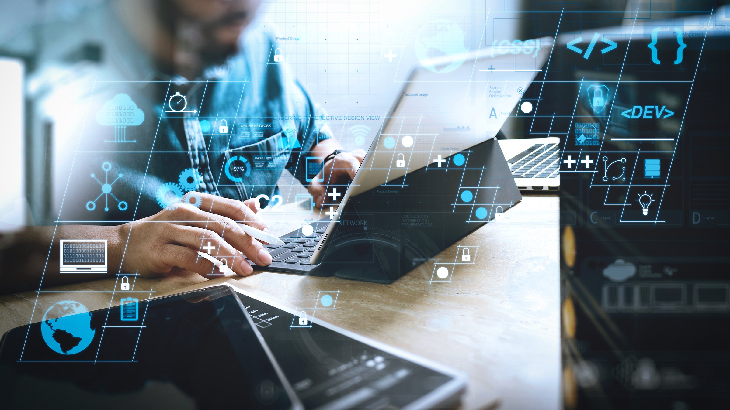 A male coding software developer works with AR tools on a laptop with superimposed icons to symbolize cybersecurity