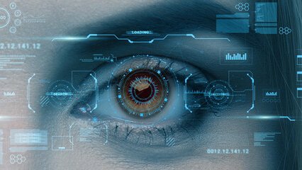 Close-up of a woman's face as she stares intently at a clear screen projecting symbols and links implying network security.