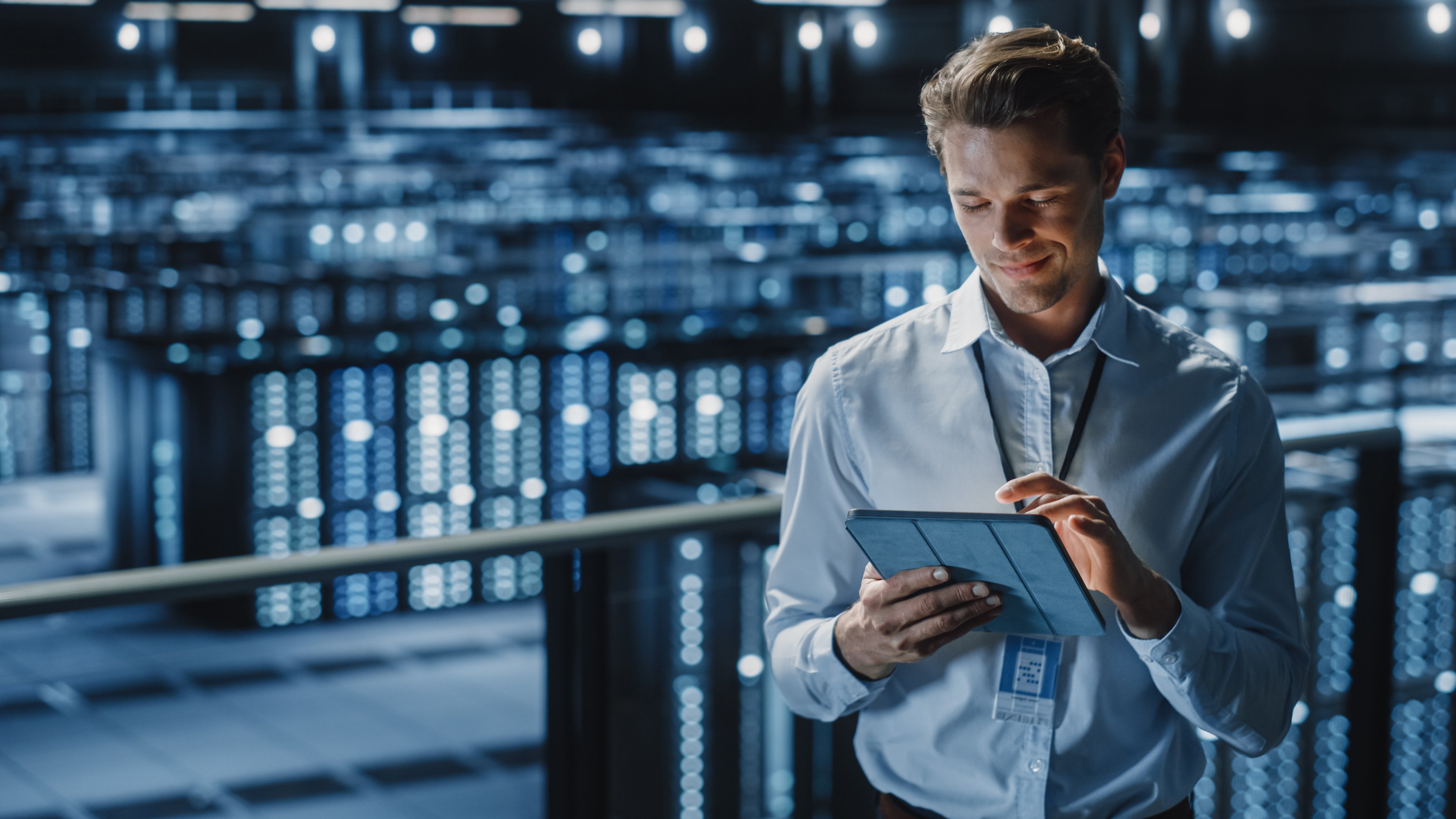 Smiling cybersecurity executive using tablet
