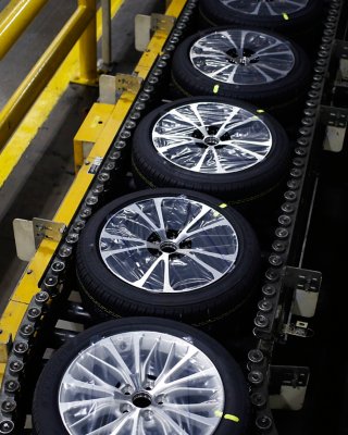 Tires moving along conveyor