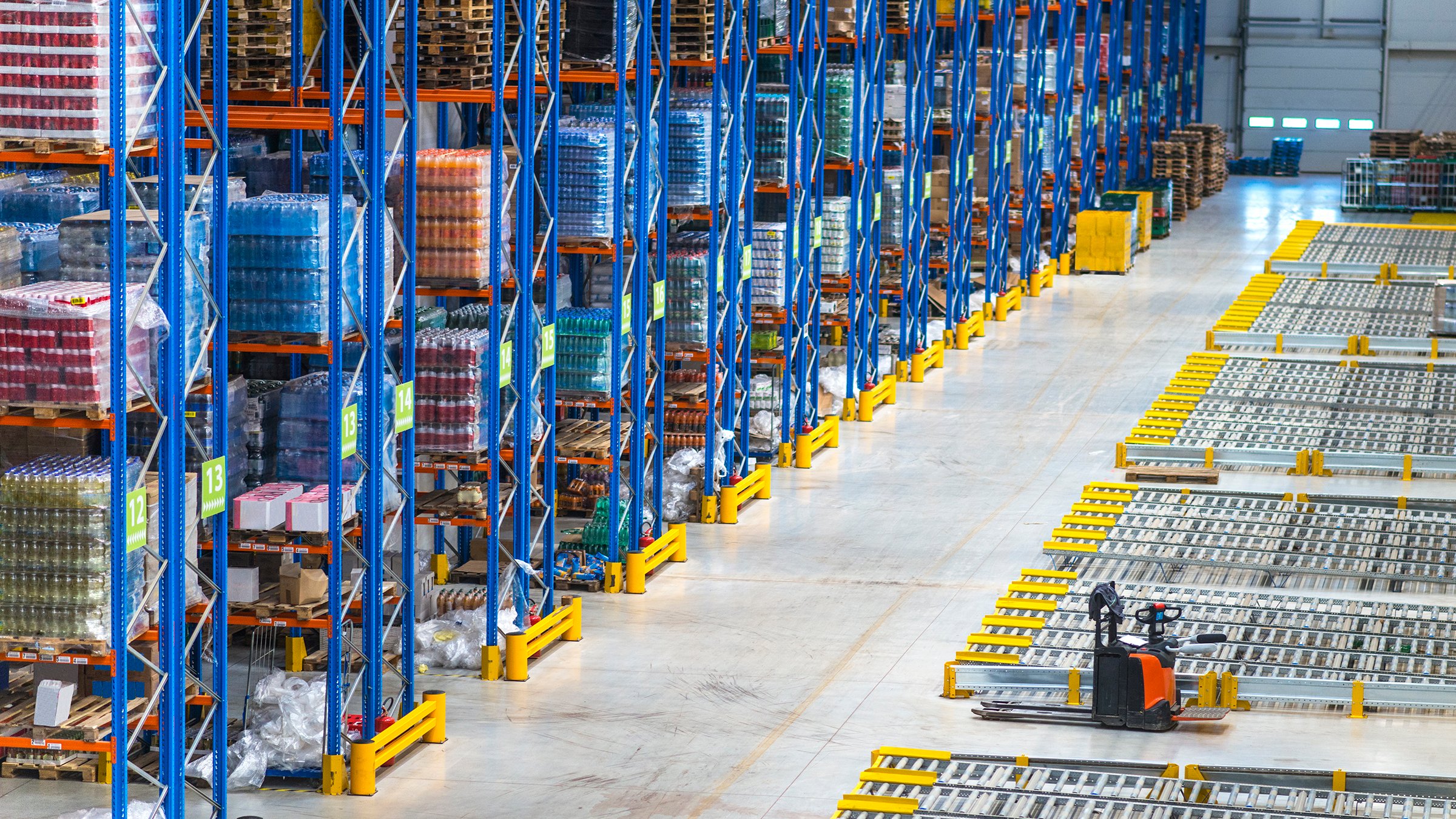 Distribution warehouse building interior and large storage area with goods on the shelf.