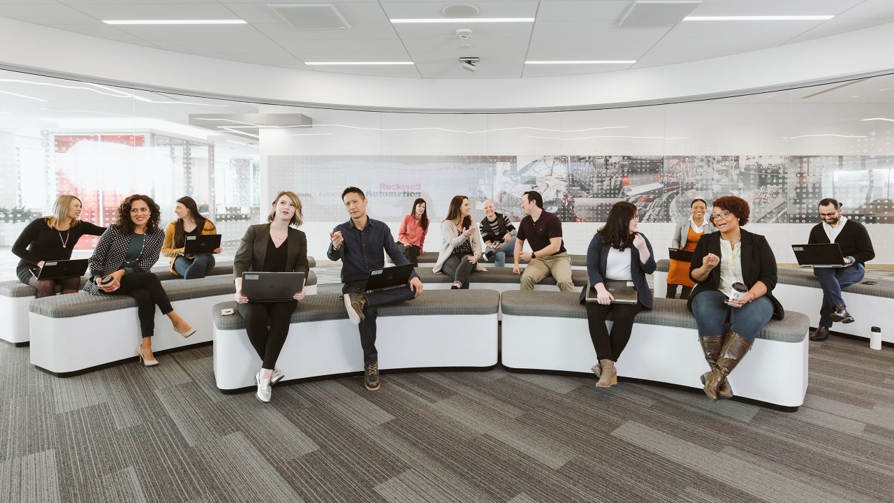 diverse group of young people sitting on couches in the Rockwell Automation Milwaukee Customer Center. Group of Rockwell employees during a presentation.
