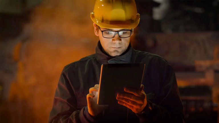 Industrial engineer analyzing data on his smart tablet
