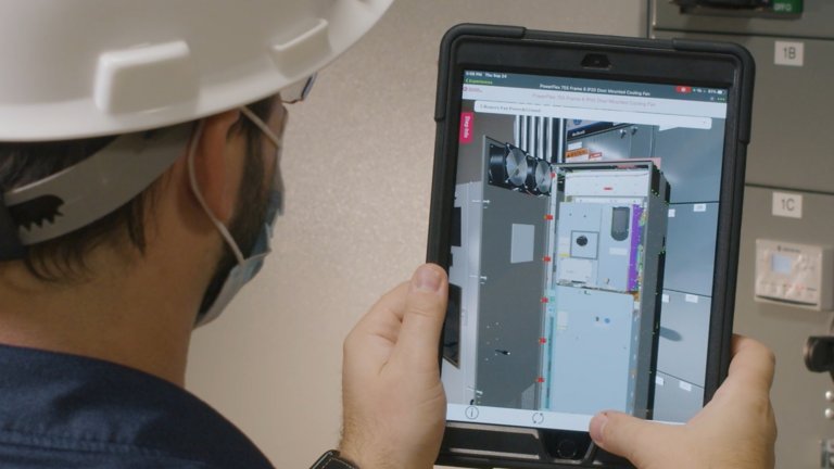 Male engineer with tablet closeup view of augmented reality software of Powerflex MCC