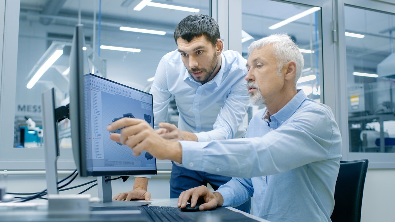 Engineers looking at computer screen