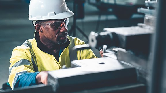 Factory worker or engineer working on a machine. 