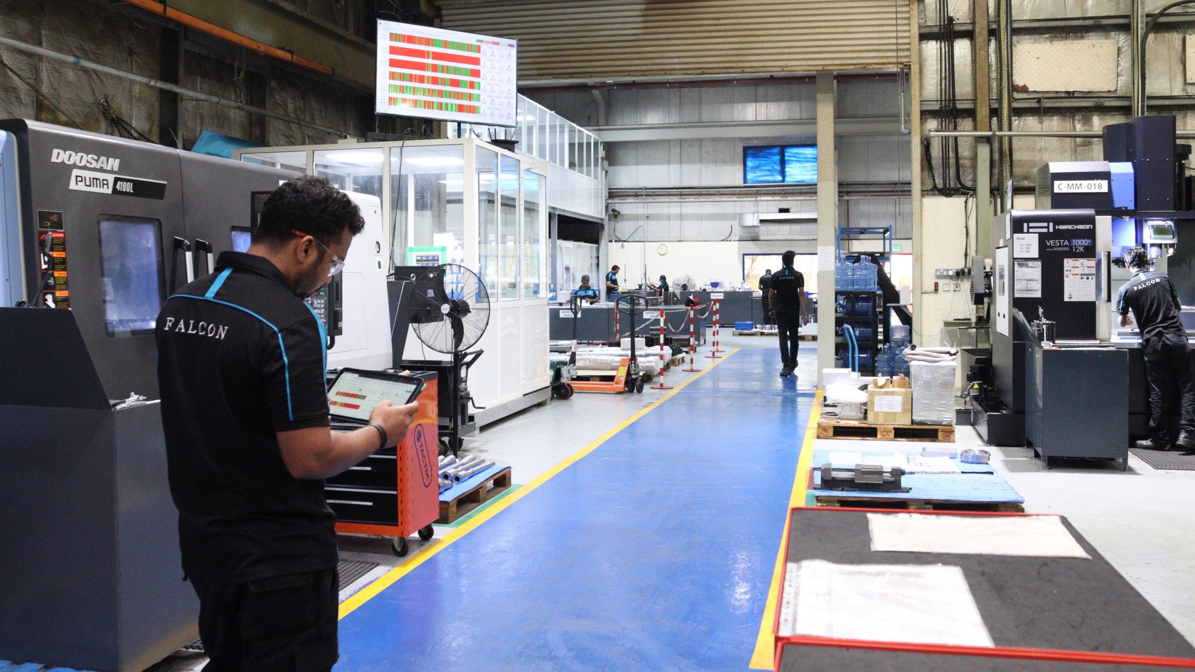 Man with tablet working on Falcon Group's shop floor