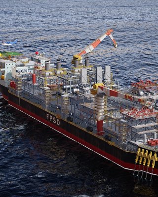 A working  FPSO vessel with an oil tanker hooked up and transferring oil, situated on the open sea with a helicopter approaching the helipad.