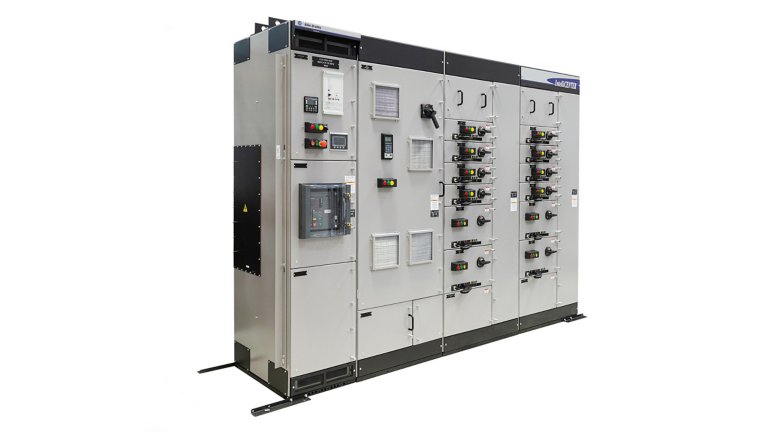 A CENTERLINE 2500 motor control center is a large industrial gray metal cabinet. On the outside, multiple sections show a combination of electronic multi-colored push buttons, touch screens, door latches with safety locking devices and baffles. Inside the MCC are electronic components for controlling motors and starters and sending data used to run industrial facilities.
