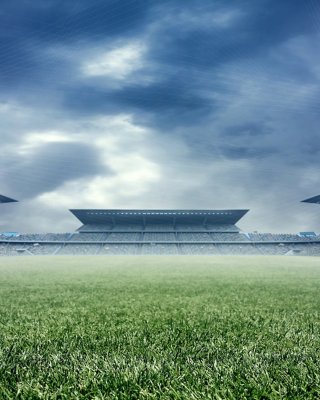 View of a football stadium lit up from the grass looking up to the sky