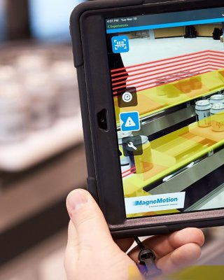 User holding an augmented reality tablet for industrial training