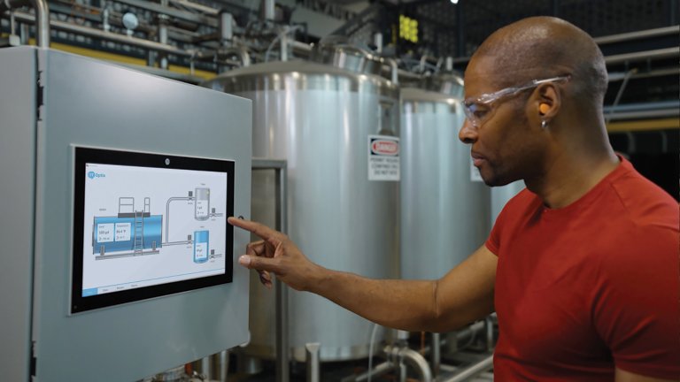 Man pointing to screen on an OptixPanel in a manufacturing area