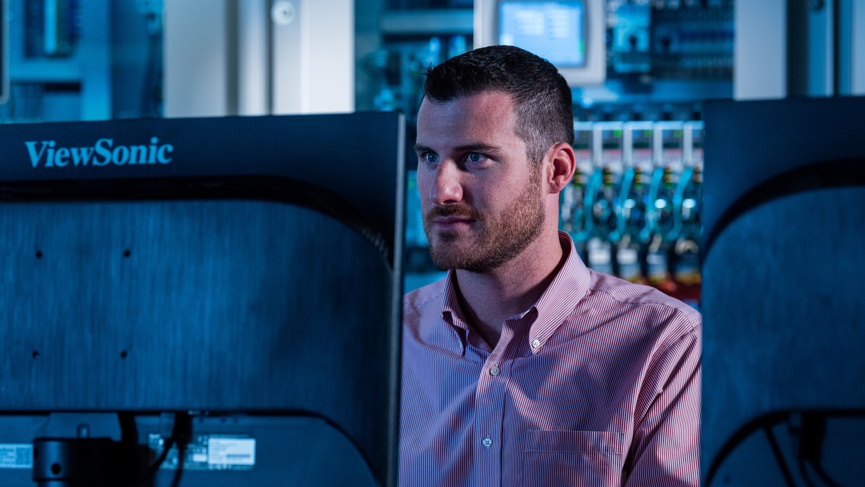 Male working on a computer looking at the monitor