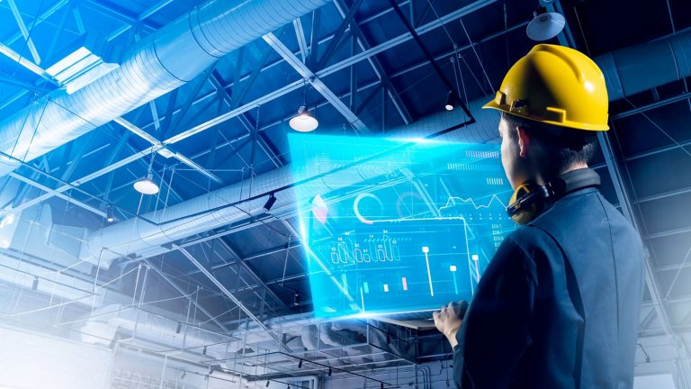 Man with hardhat standing in front of  industrial futuristic monitor.