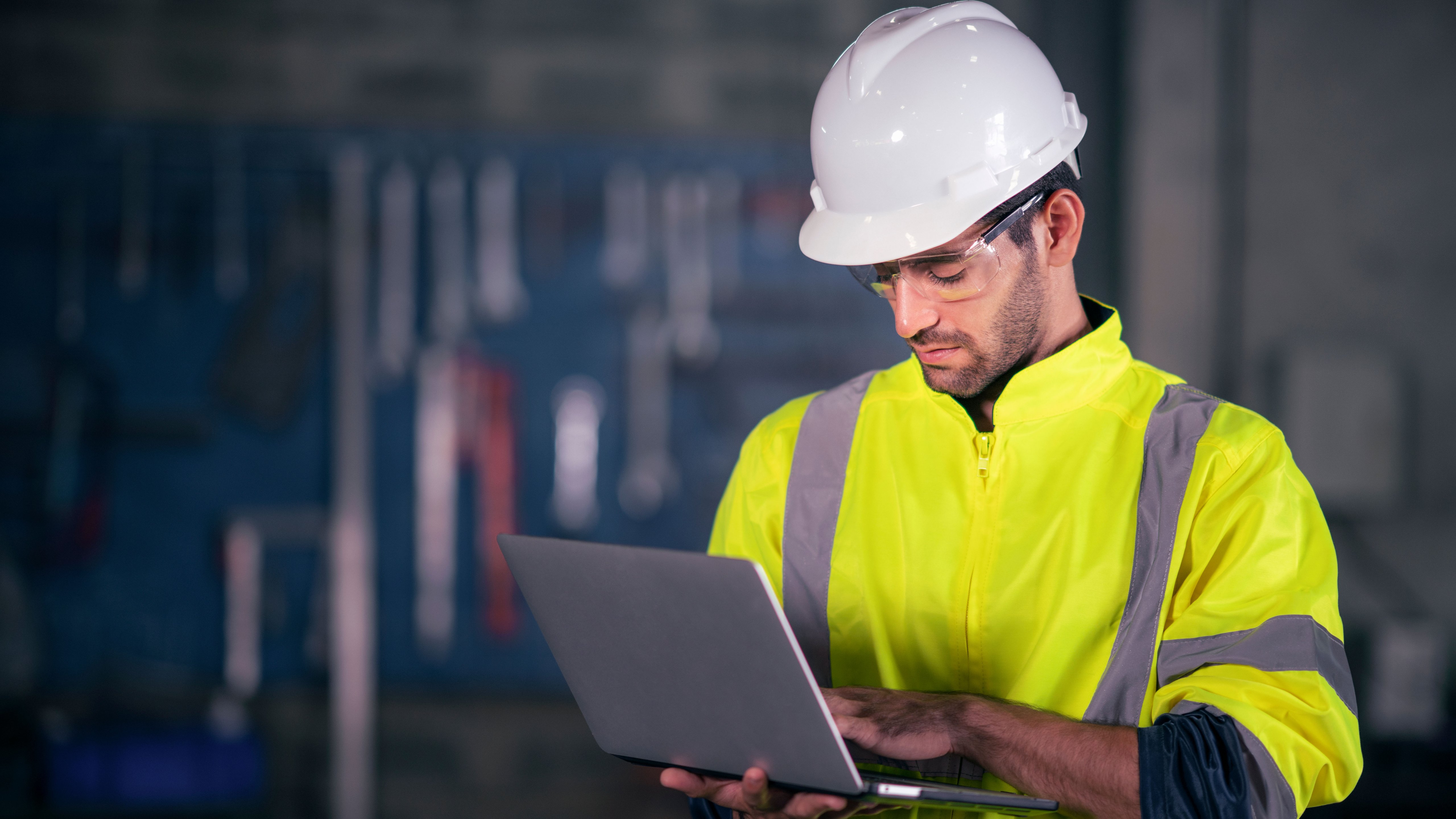 Man in helmet is holding his laptop