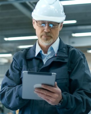 Man on factory floor with tablet