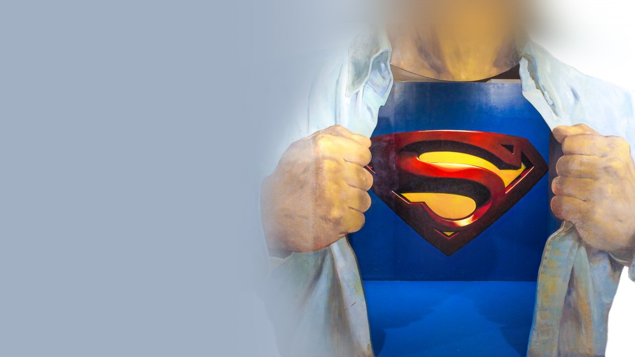 Man opening shirt to reveal he is actually a superman-type figure under clothing.