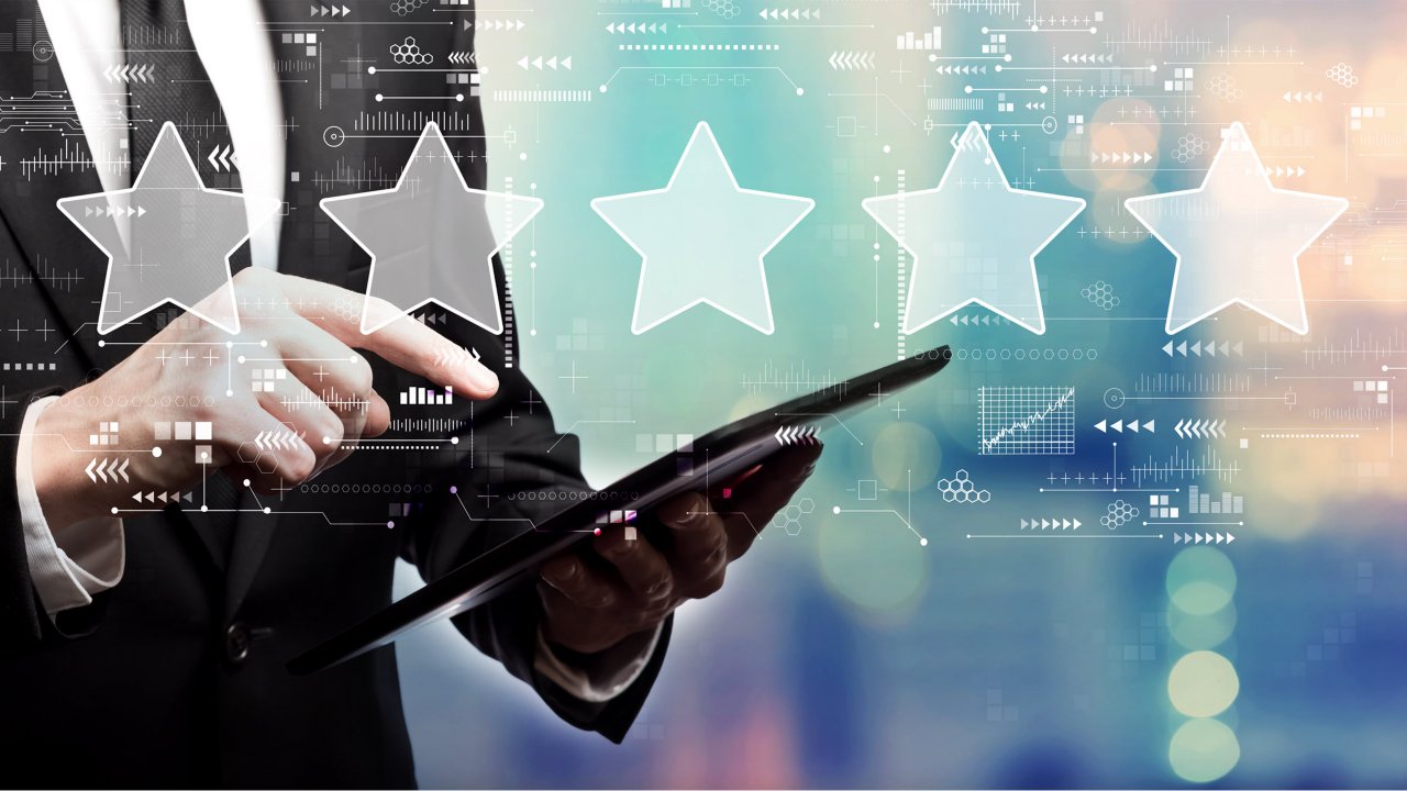 rating star concept with businessman using his tablet computer