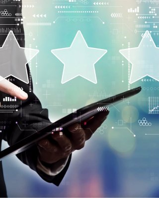 rating star concept with businessman using his tablet computer