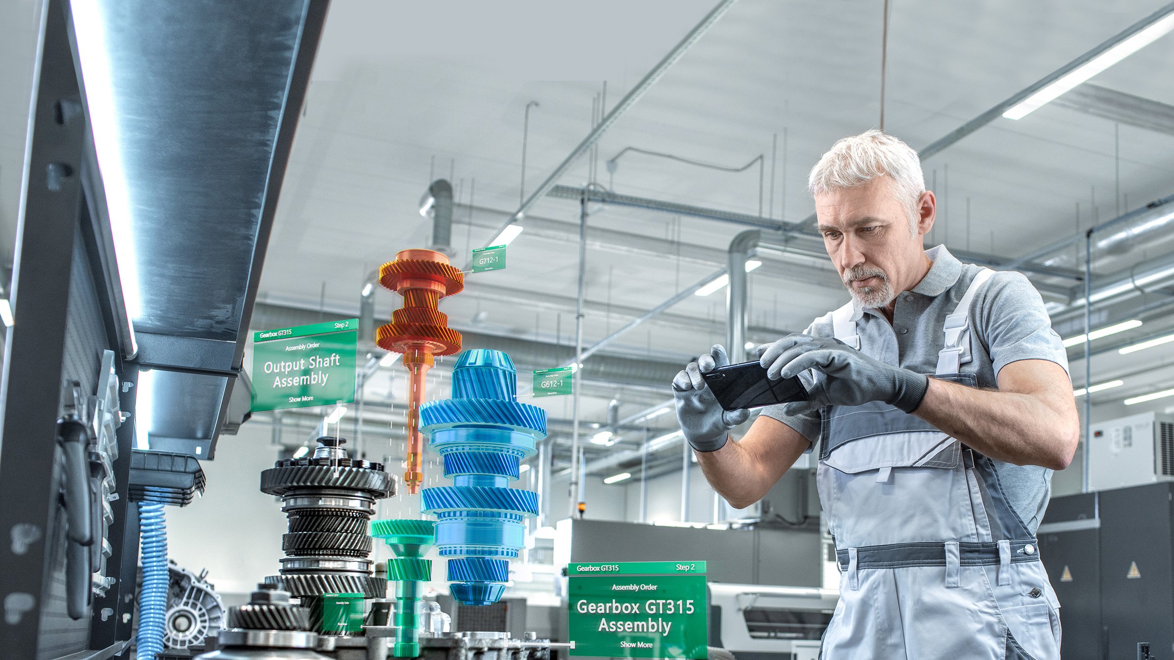 White haired man using smart phone with FactoryTalk Vuforia Factory virtual reality. Image shows the instructions that are seen on screen via VR.