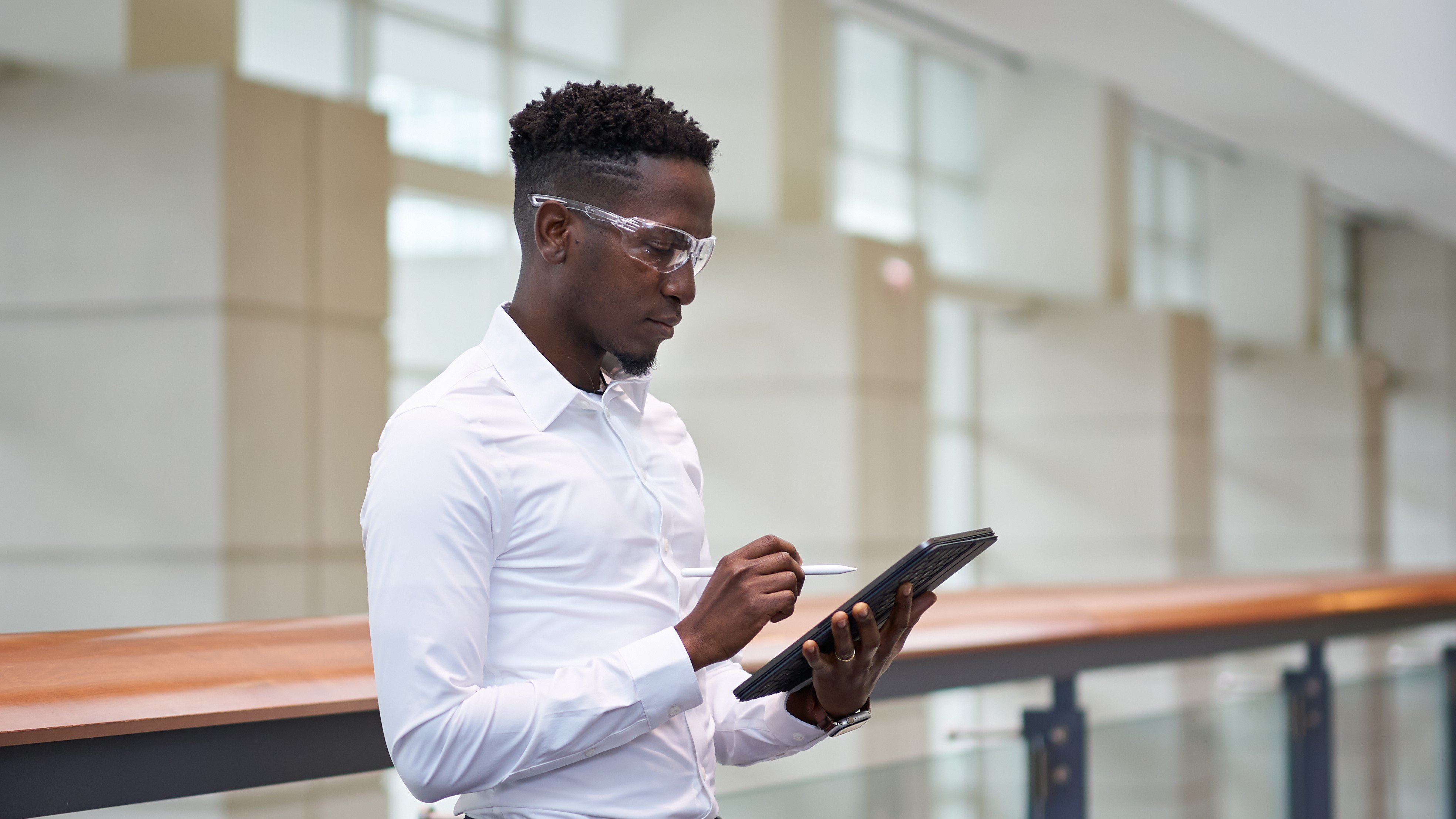 Man using tablet in manufacture