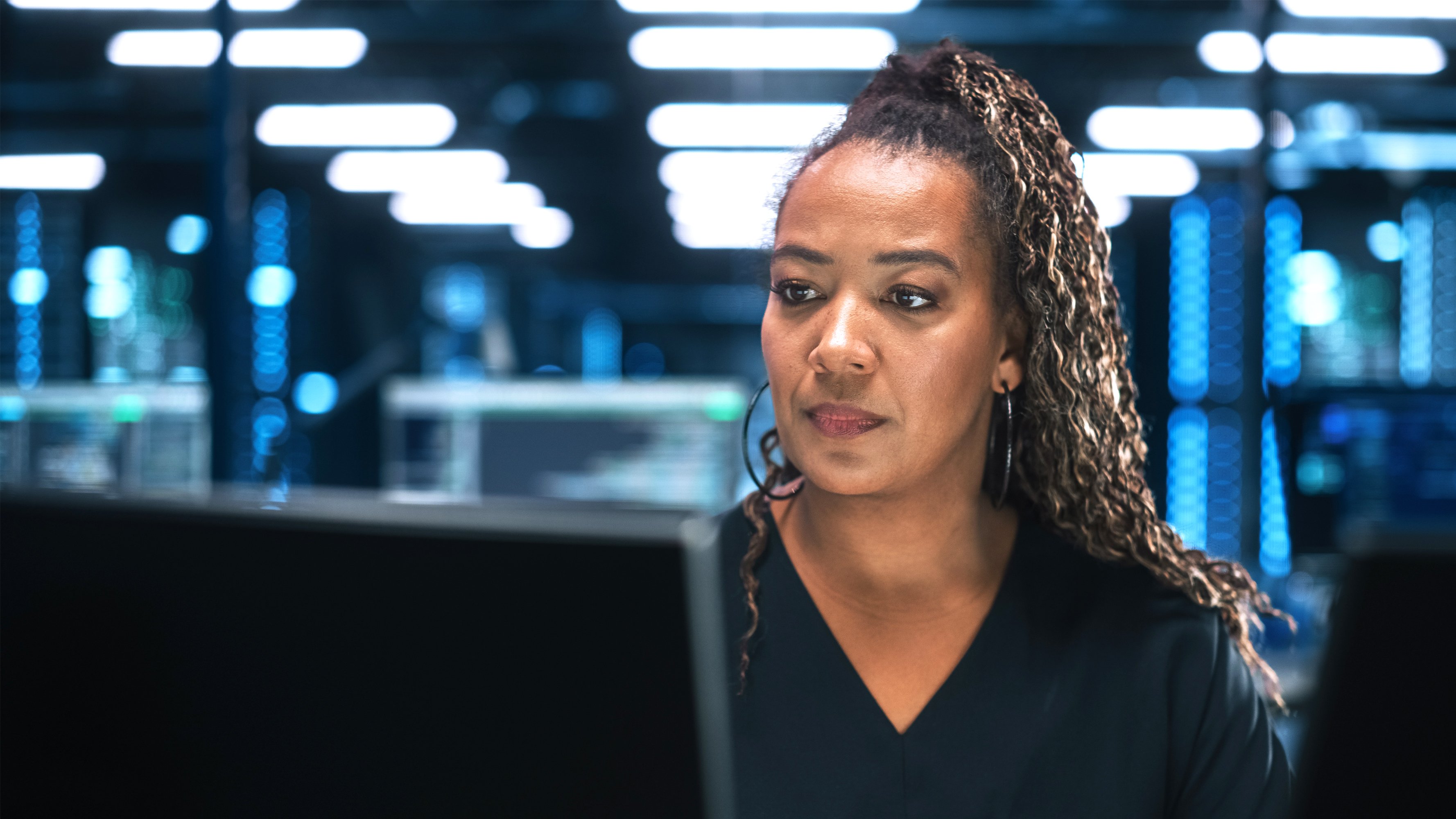 Female manager specialist working on computer in IT office environment