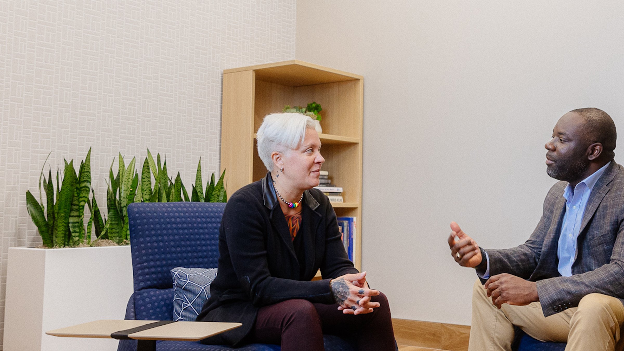 A white woman employee and Black man employee talk at Rockwell Automation Milwaukee headquarters.