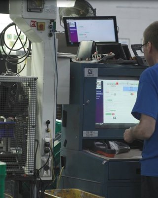 Worker at Kendrick Plastics uses MES system at workstation